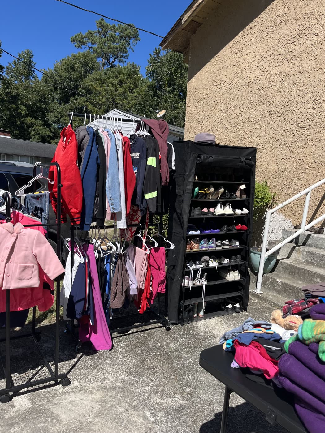 Racks of free clothing and shoes set out for neighbors